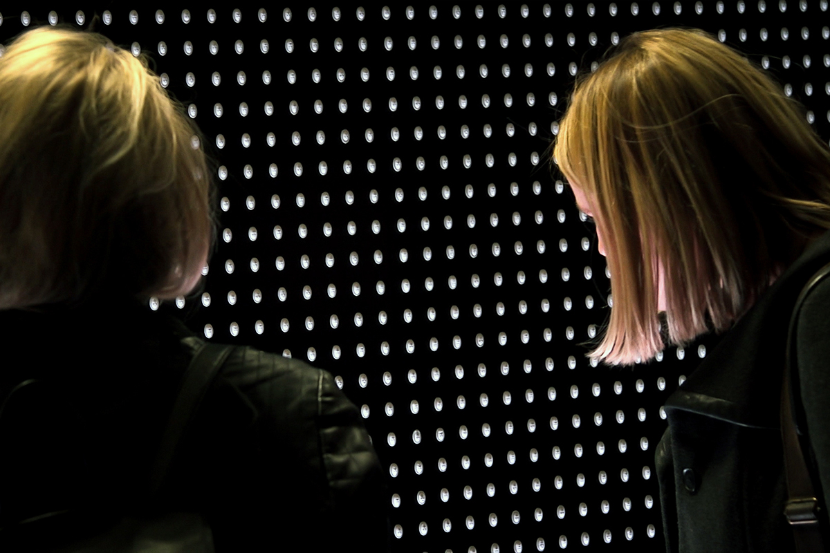 Prescribed to Death. Wall of faces carved on opioid pills.